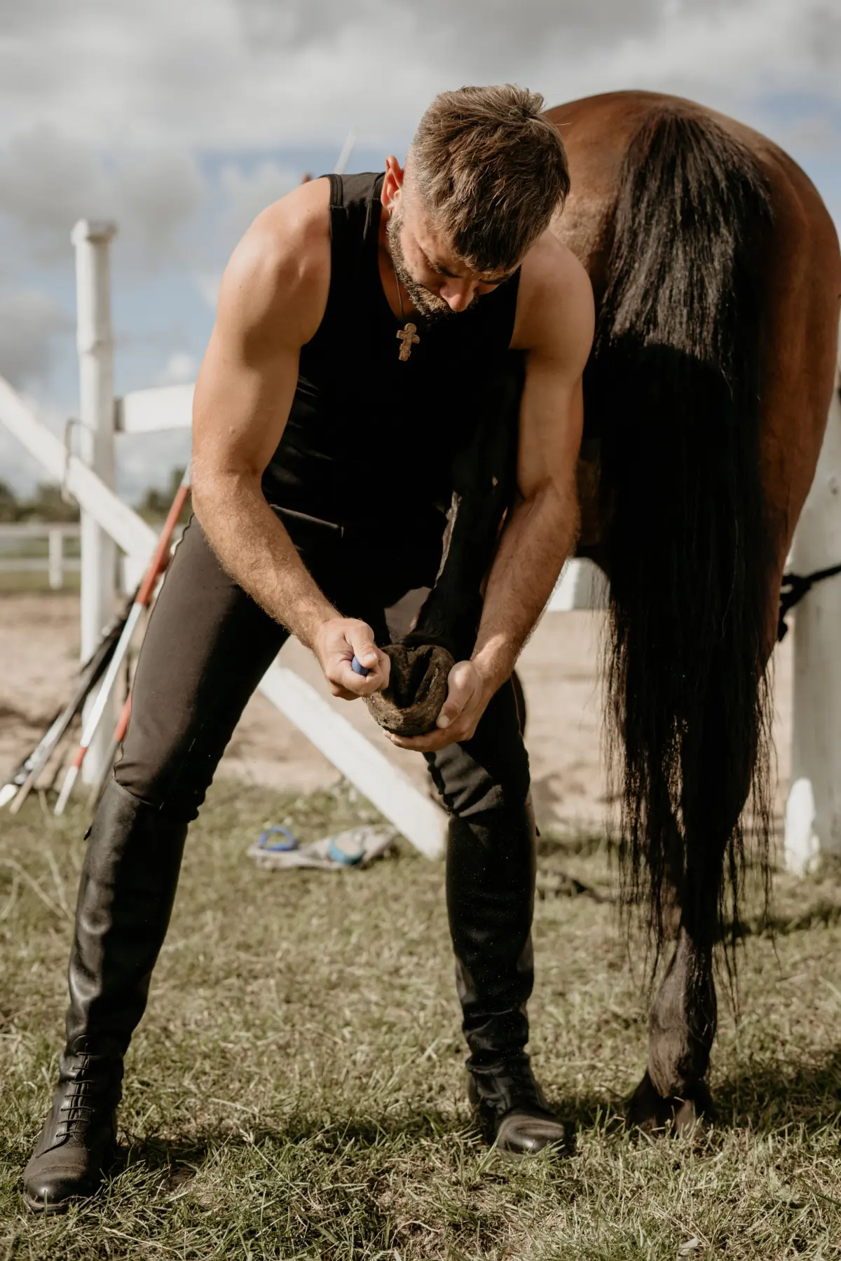 A farrier changes a horseshoe